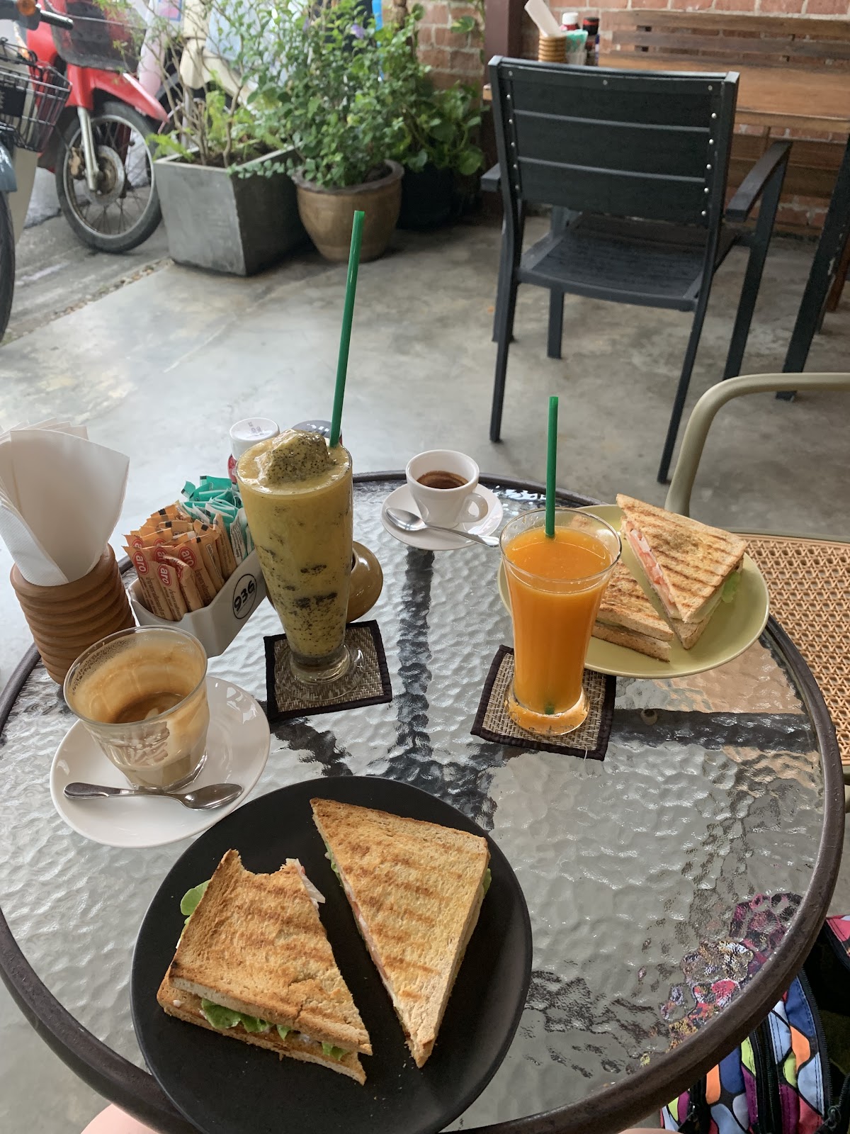 Table spread with fresh juices and sandwiches